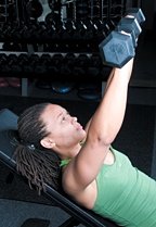 Chelsea Cooper performing incline dumbbell chest press. - Copyright – Stock Photo / Register Mark