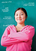 Girl standing in front of blackboard with arms folded. - Copyright – Stock Photo / Register Mark